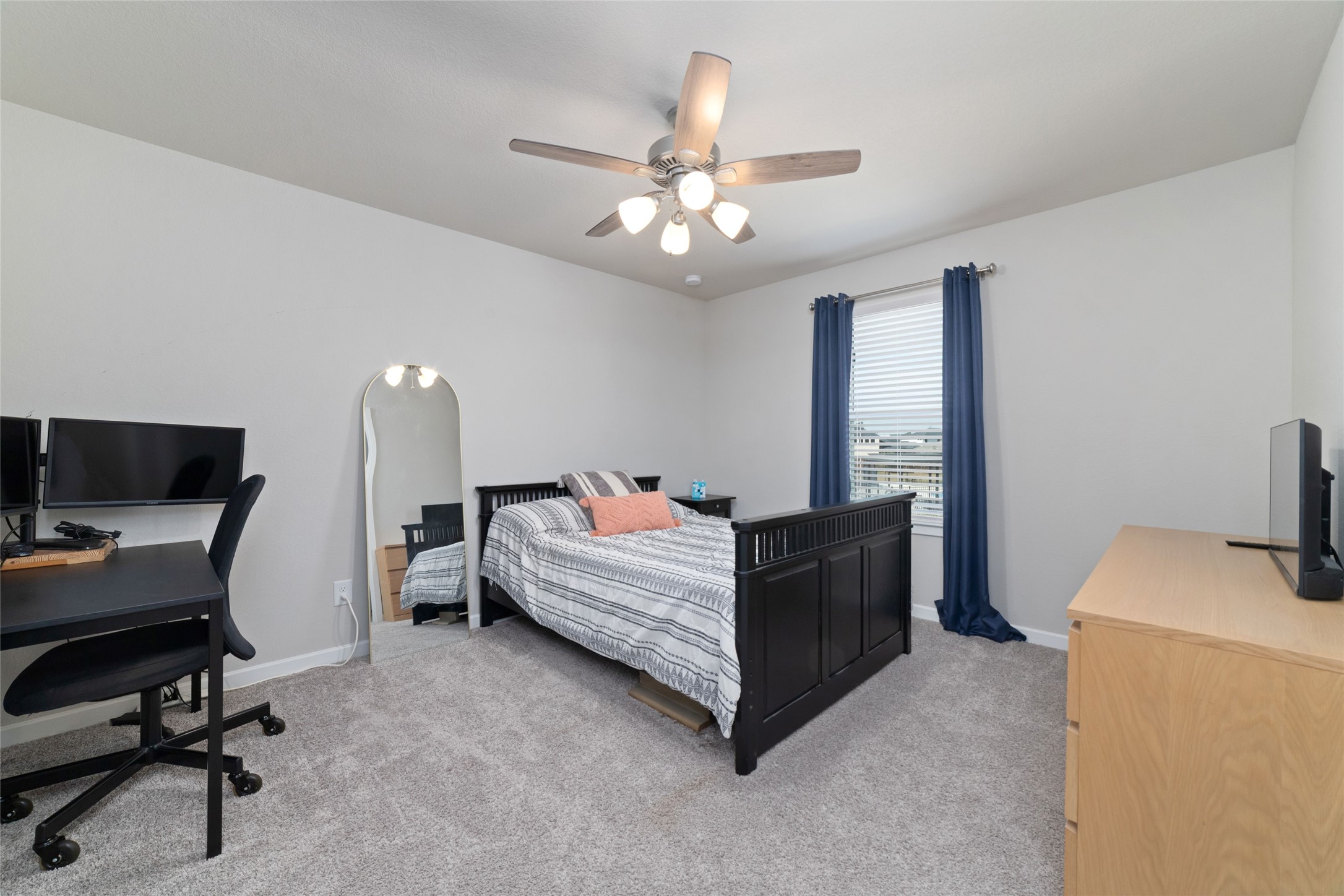 22122 Sam Raburn Drive Tomball, TX 77375 - Photo 35 of 47 a bedroom with a bed and a chandelier