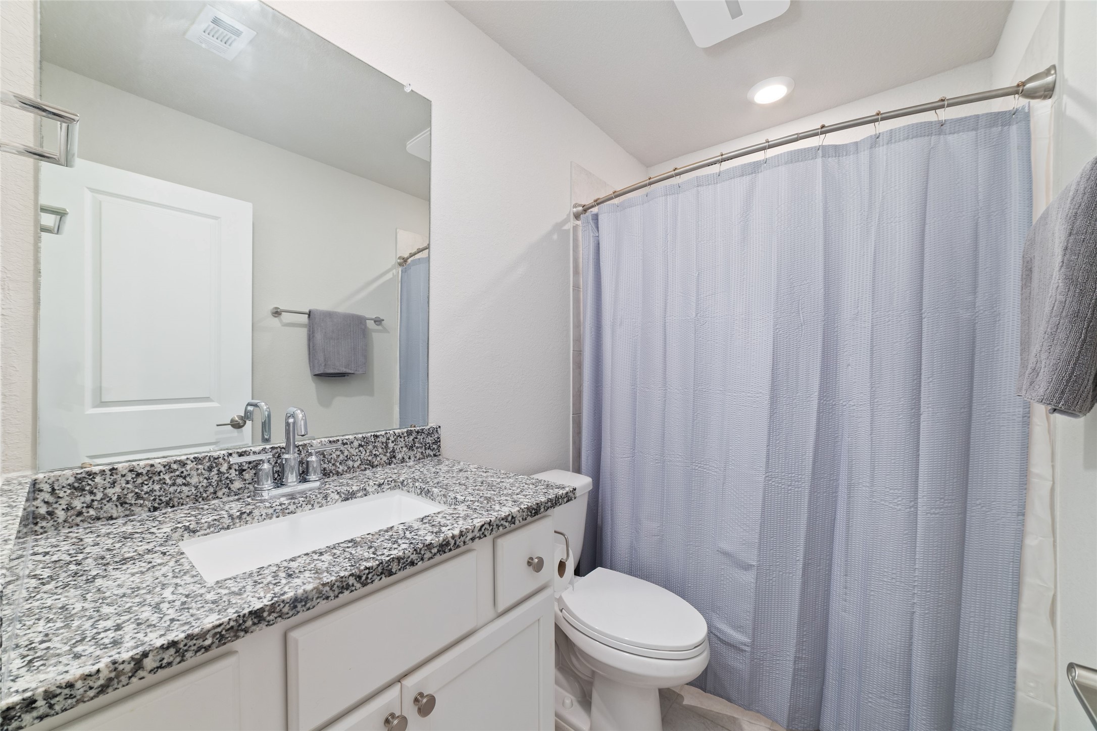 22122 Sam Raburn Drive Tomball, TX 77375 - Photo 36 of 47 a bathroom with a granite countertop sink and a mirror