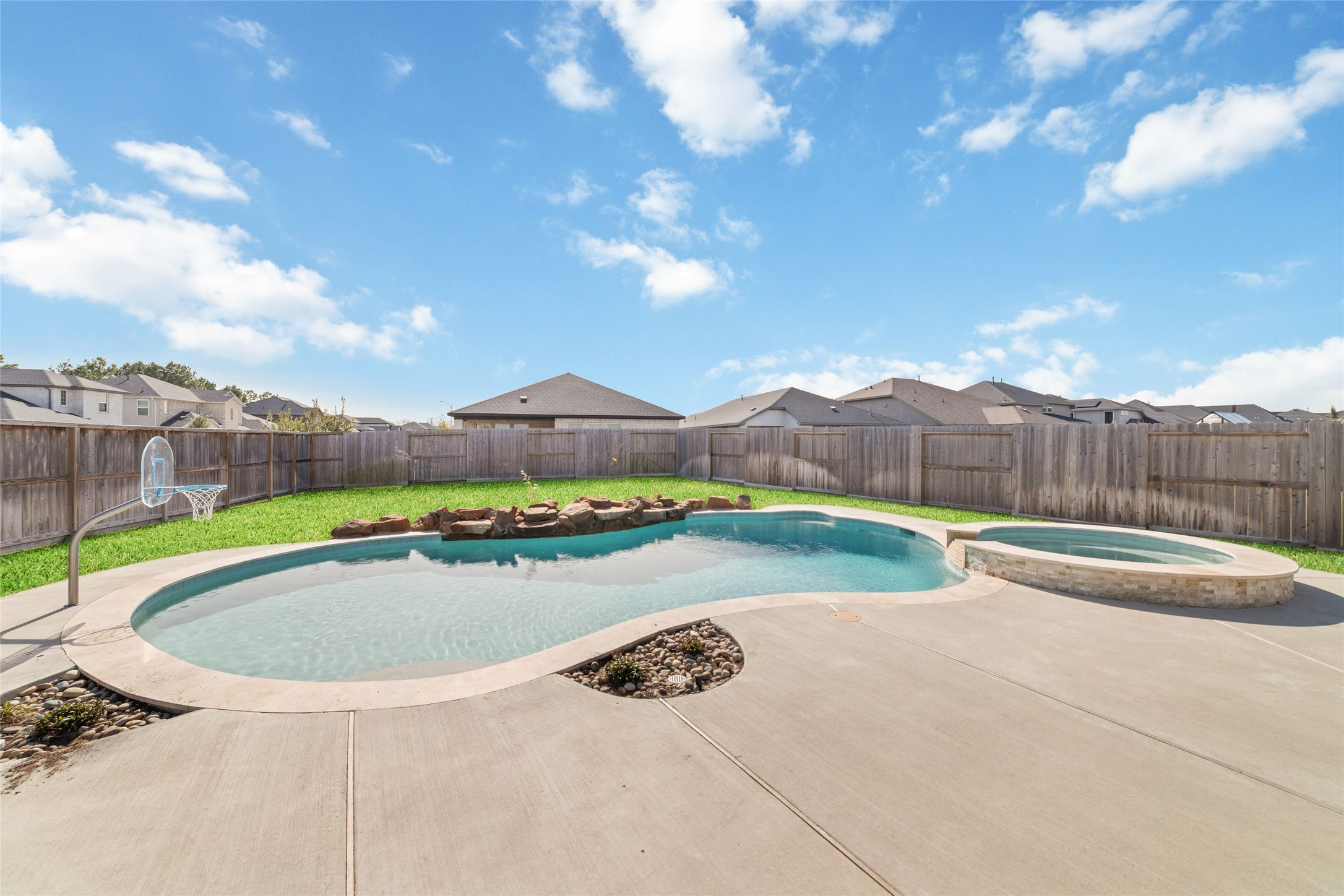 22122 Sam Raburn Drive Tomball, TX 77375 - Photo 39 of 47 Looking form the home's covered patio! What a view of the sparkling pool/spa and pluch green grass thanks to the Sprinkler system in the front and back yard!