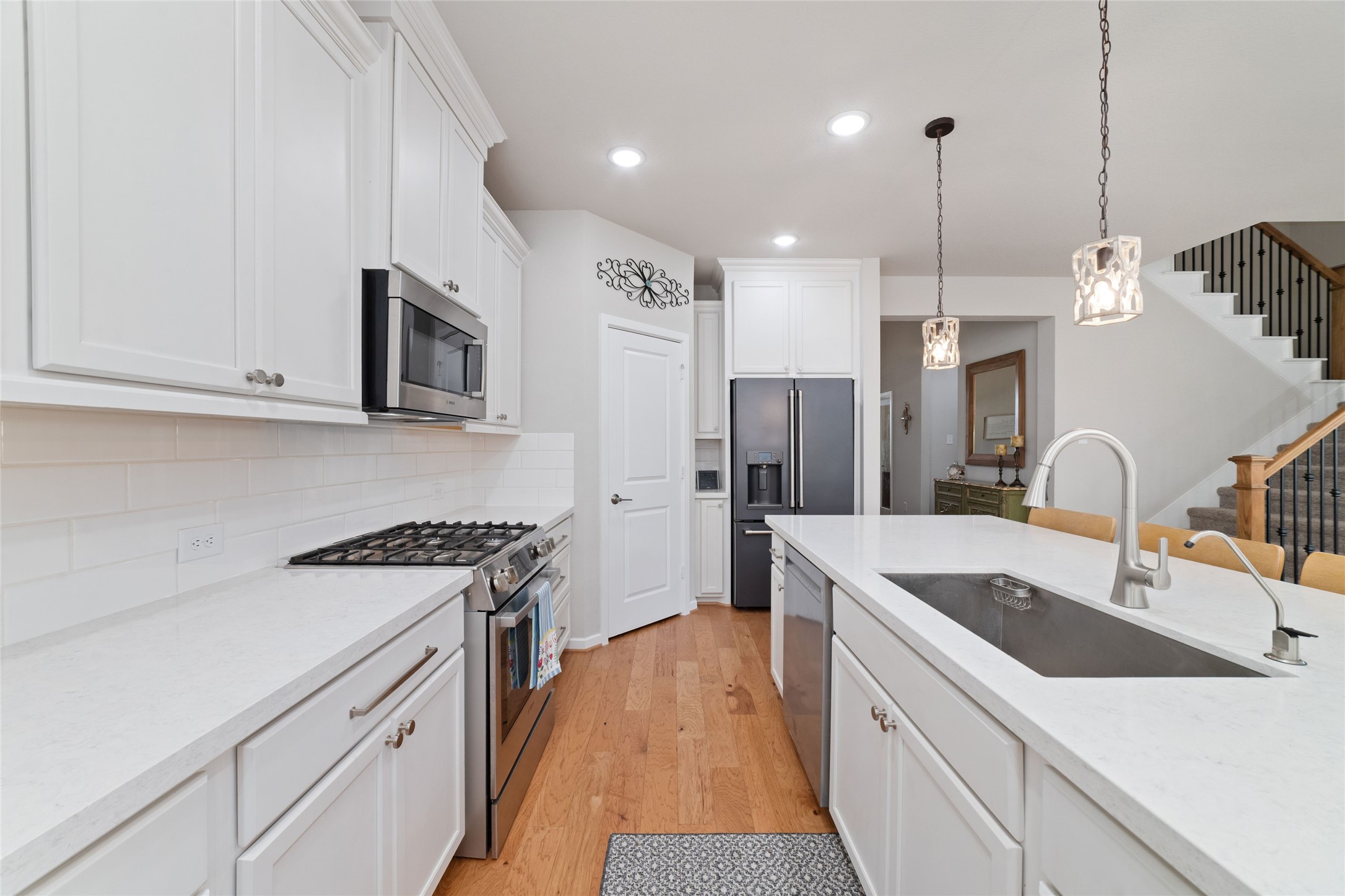 22122 Sam Raburn Drive Tomball, TX 77375 - Photo 10 of 47 A chefs dream! Bosch appliances, quartz counter tops, white cabinets with a walk in pantry.