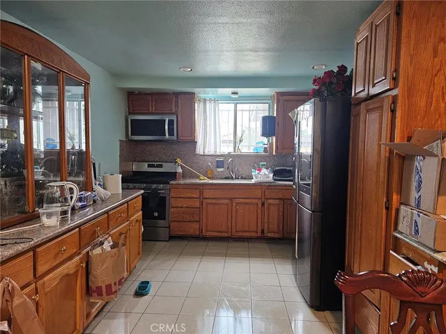a kitchen with a sink stove and refrigerator