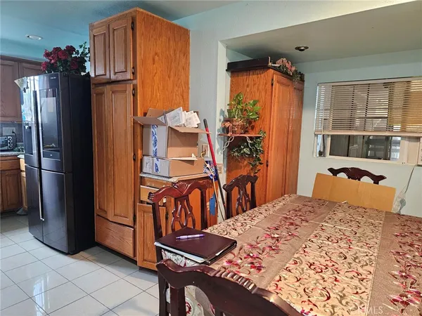 a bedroom with a bed and a refrigerator