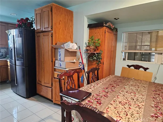 a bedroom with a bed and a refrigerator