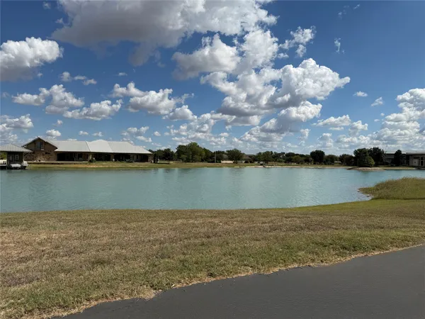a view of a lake with houses in back