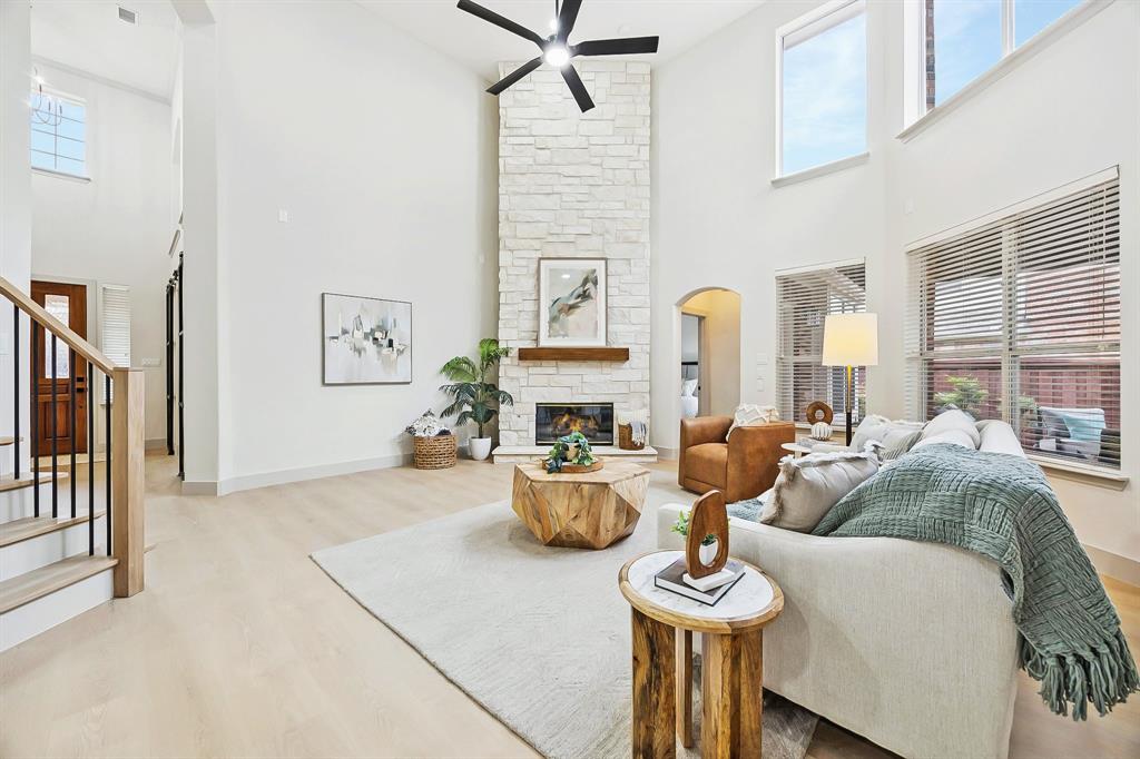 a living room with fireplace furniture and a window