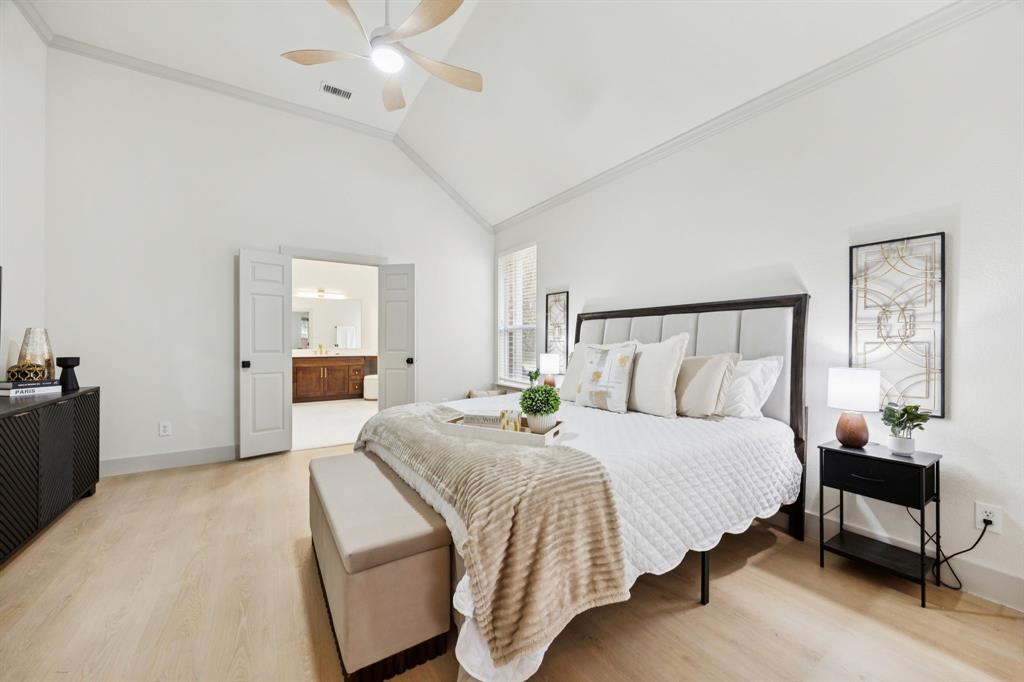 2437 Clear Field Drive Plano, TX 75025 - Photo 16 of 38 a bedroom with a large bed and a chandelier