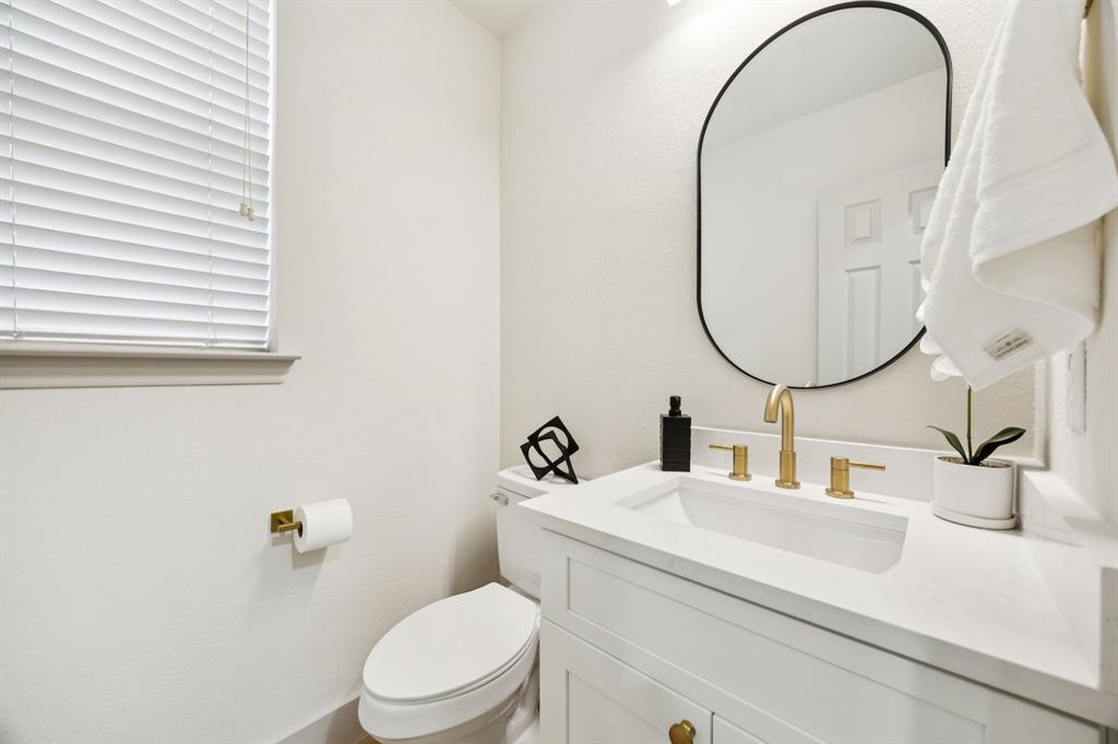 2437 Clear Field Drive Plano, TX 75025 - Photo 22 of 38 a bathroom with a sink and a mirror
