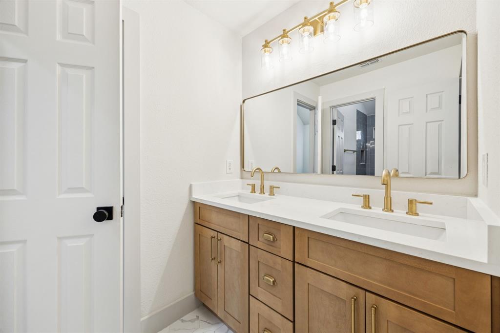 2437 Clear Field Drive Plano, TX 75025 - Photo 28 of 38 a bathroom with a sink and a mirror