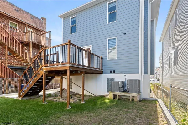 a kitchen with stainless steel appliances a refrigerator a stove a sink a dining table and chairs