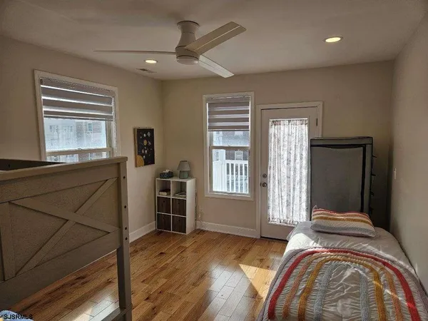 a bedroom with a large bed and a dresser