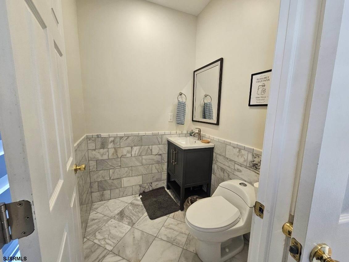 27 South Little Rock Avenue, Unit MAY 2026 Ventnor City, NJ 08406 - Photo 33 of 91 a bathroom with a sink toilet and mirror