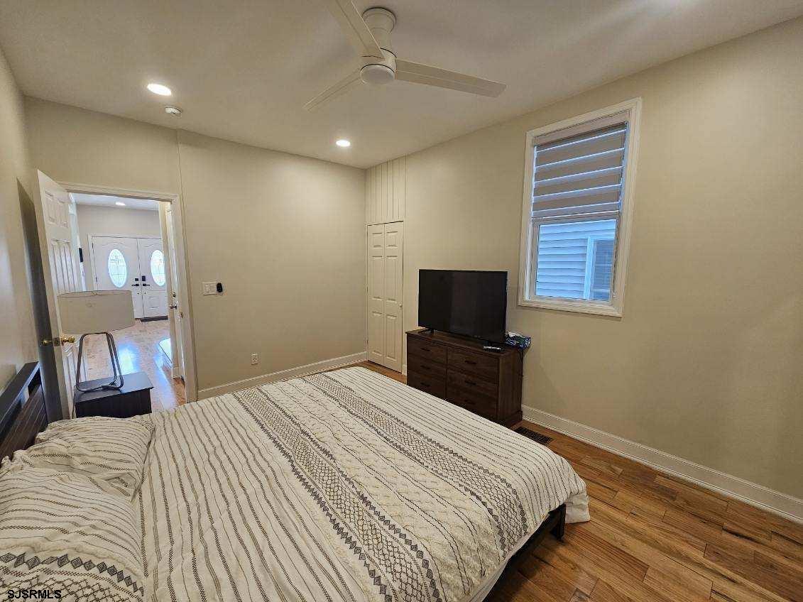 27 South Little Rock Avenue, Unit MAY 2026 Ventnor City, NJ 08406 - Photo 36 of 91 a bedroom with a bed and a television