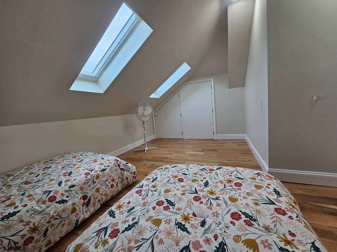 27 South Little Rock Avenue, Unit MAY 2026 Ventnor City, NJ 08406 - Photo 48 of 91 a bedroom with a bed and a window