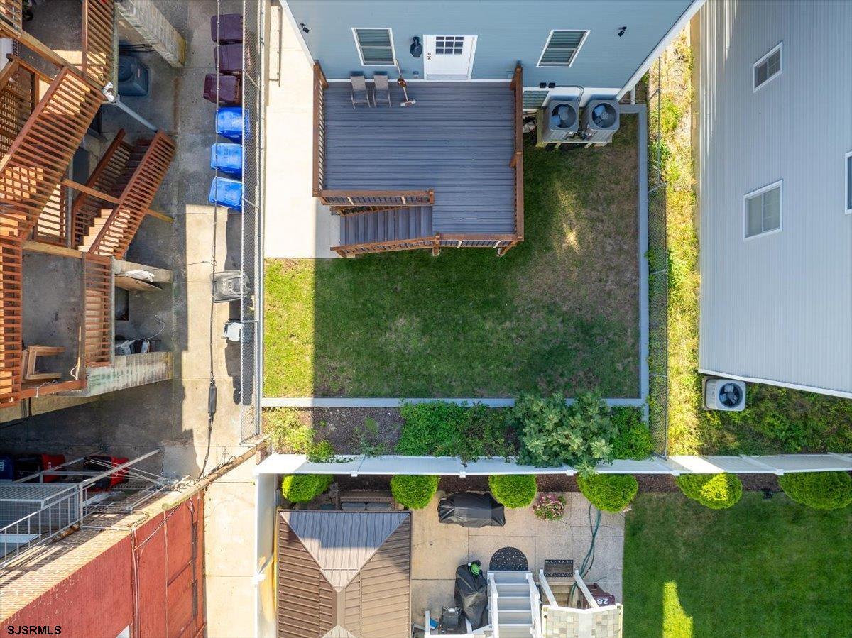 27 South Little Rock Avenue, Unit MAY 2026 Ventnor City, NJ 08406 - Photo 61 of 91 a backyard of a house with a fountain swing table and chairs