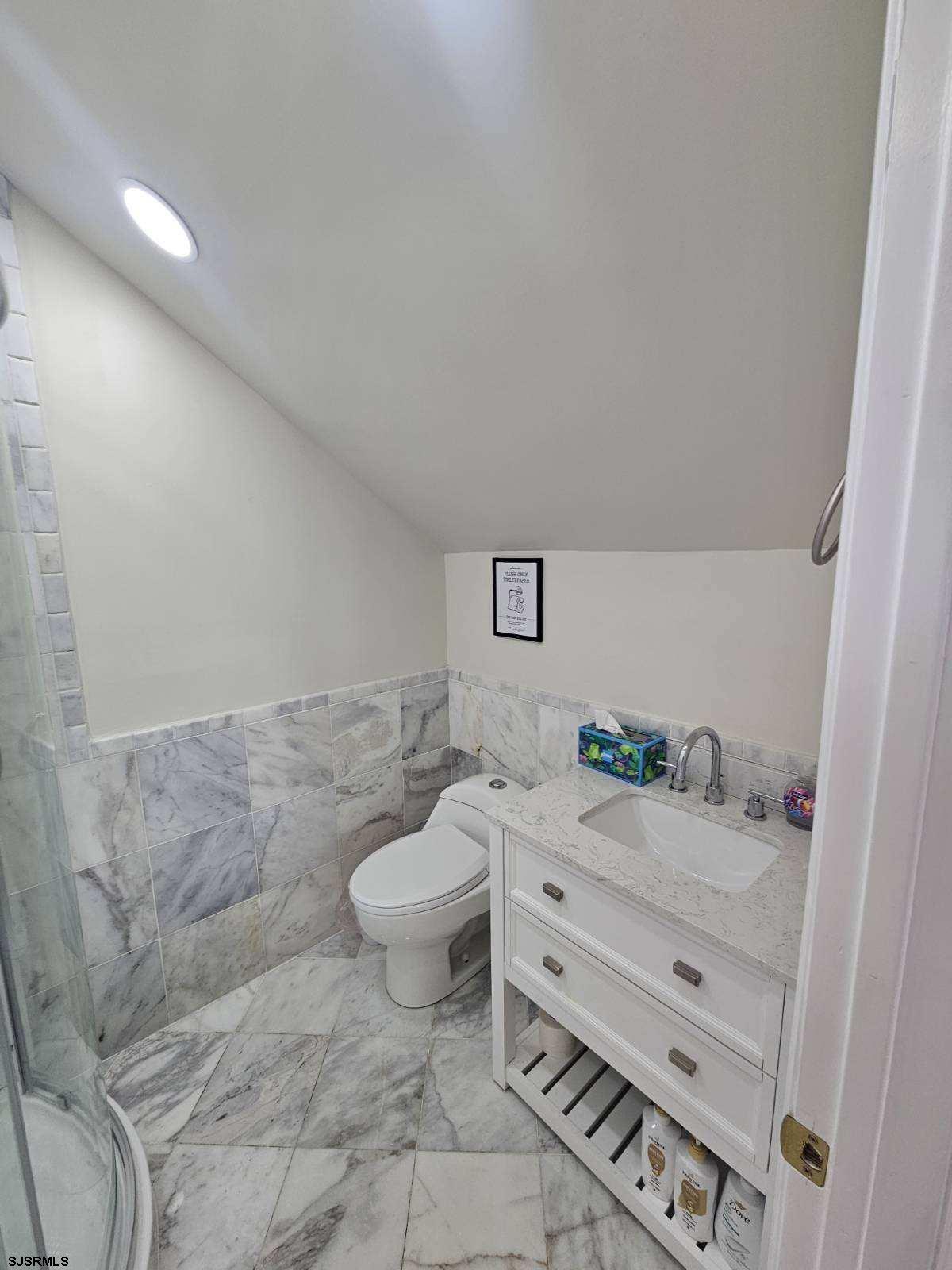 27 South Little Rock Avenue, Unit MAY 2026 Ventnor City, NJ 08406 - Photo 85 of 91 a bathroom with a granite countertop sink mirror vanity and toilet