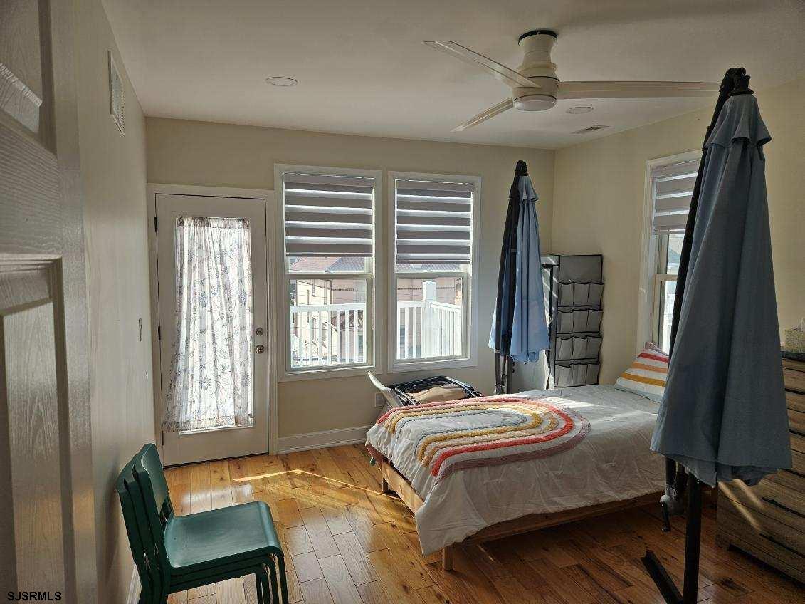 27 South Little Rock Avenue, Unit MAY 2026 Ventnor City, NJ 08406 - Photo 87 of 91 a bedroom with a bed window and a chair