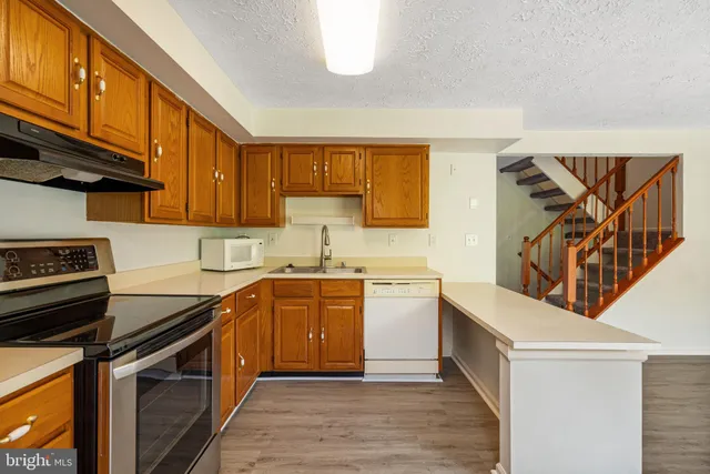 a kitchen with a stove microwave and door