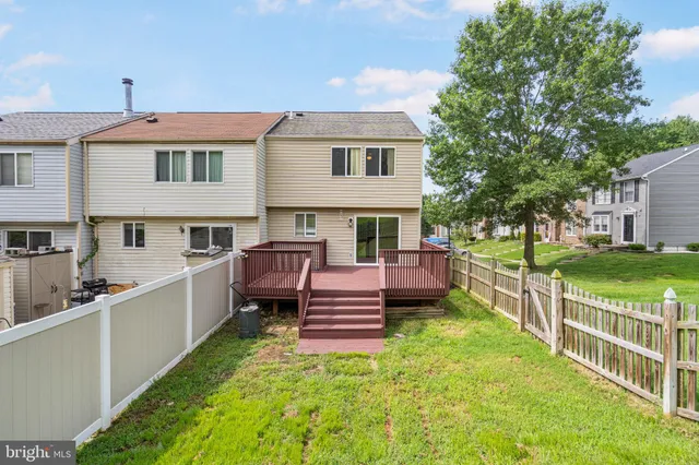 a view of a chair and table in the backyard