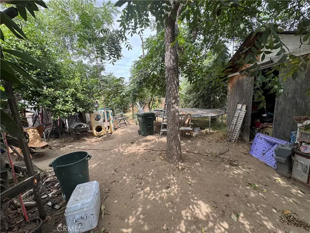 a backyard of a house with barbeque oven table and chairs