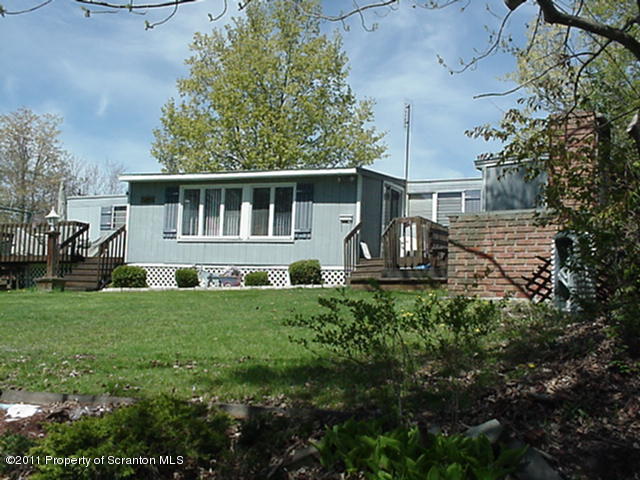 0 Cottrell Road Union Dale, PA 18470 - Photo 1 of 10 a front view of house with yard and green space
