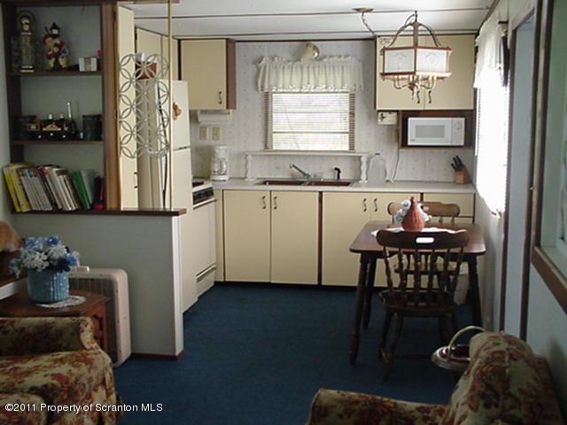 0 Cottrell Road Union Dale, PA 18470 - Photo 4 of 10 a kitchen with a refrigerator and a table
