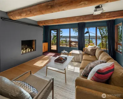 a living room with furniture and a floor to ceiling window