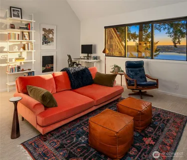 a living room with furniture fireplace and flat screen tv