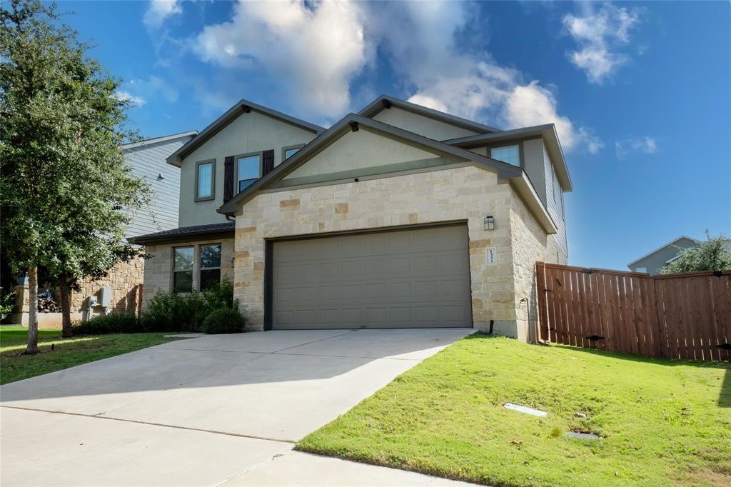 1333 Terrace View Drive Georgetown, TX 78628 - Photo 5 of 35 A striking contemporary facade with a stone-clad garage and manicured lawn welcomes you home.