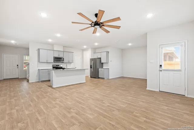 a view of kitchen with refrigerator and window