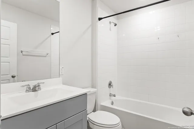 an empty room with a window and a ceiling fan