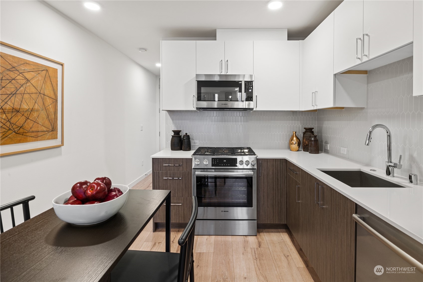 1425 East Howell Street Seattle, WA 98122 - Photo 6 of 20 a kitchen with stainless steel appliances a sink a stove and cabinets