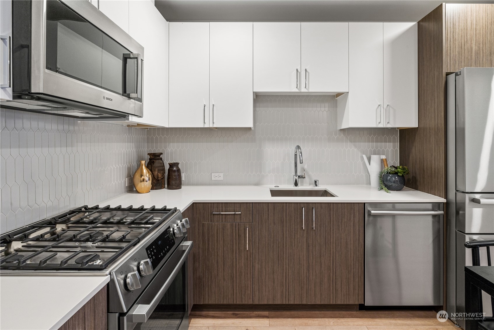 1425 East Howell Street Seattle, WA 98122 - Photo 7 of 20 a kitchen with stainless steel appliances a stove a microwave a sink and cabinets