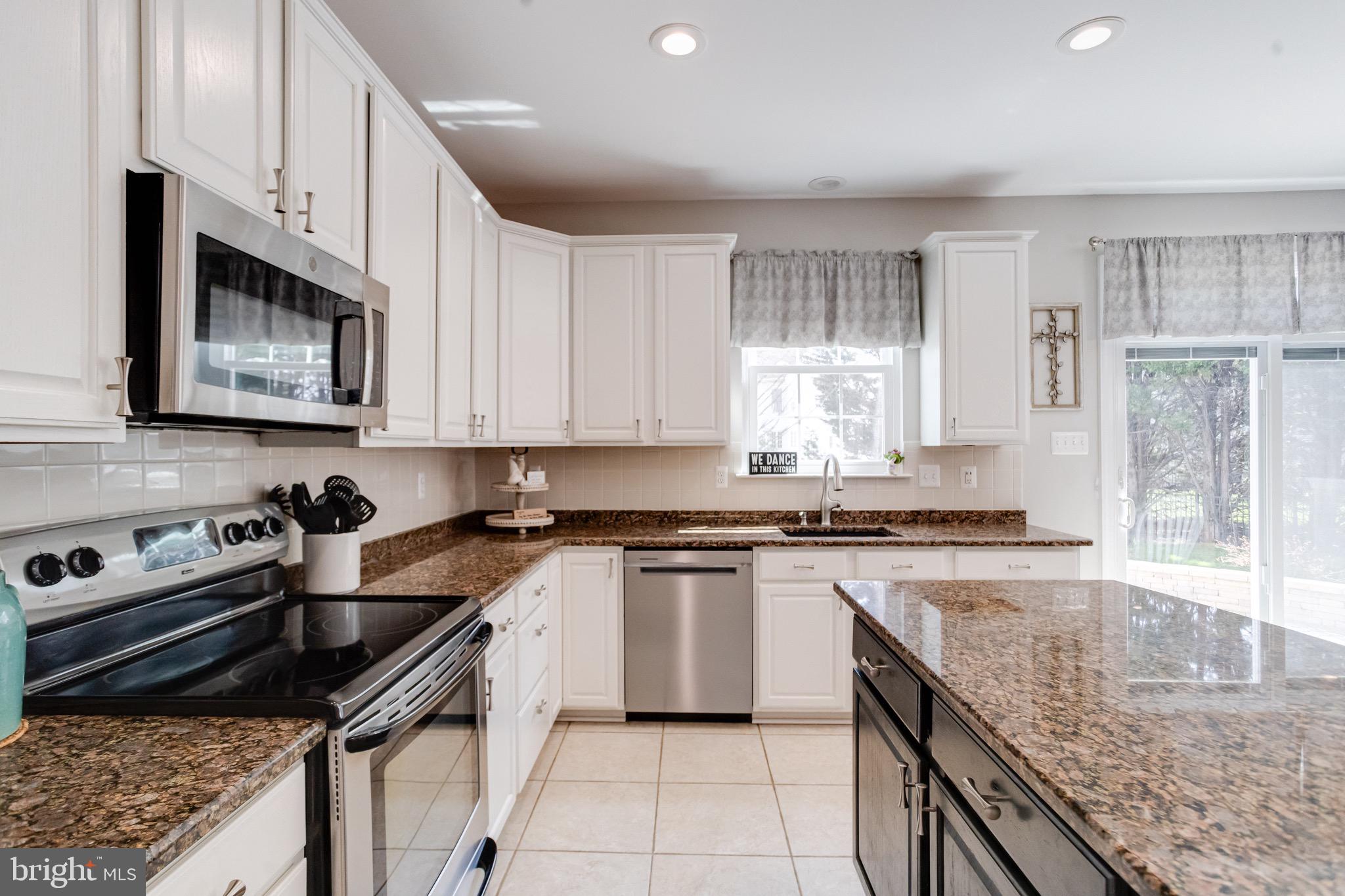 1705 Stone Ridge Court Bel Air, MD 21015 - Photo 29 of 81 a kitchen with stainless steel appliances granite countertop a stove a sink and a microwave