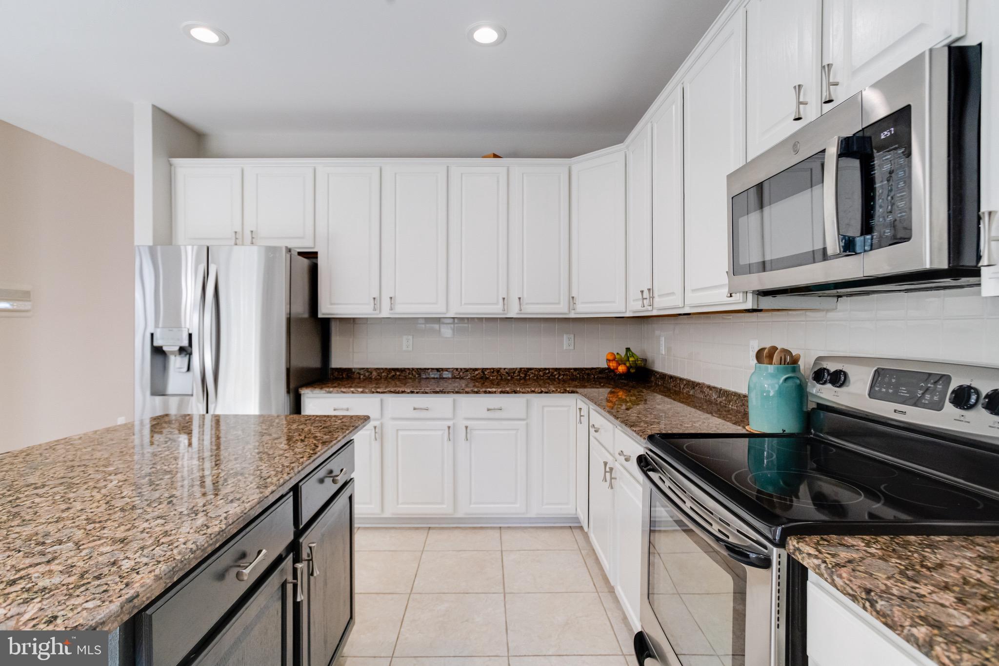 1705 Stone Ridge Court Bel Air, MD 21015 - Photo 31 of 81 a kitchen with stainless steel appliances granite countertop a sink stove and refrigerator