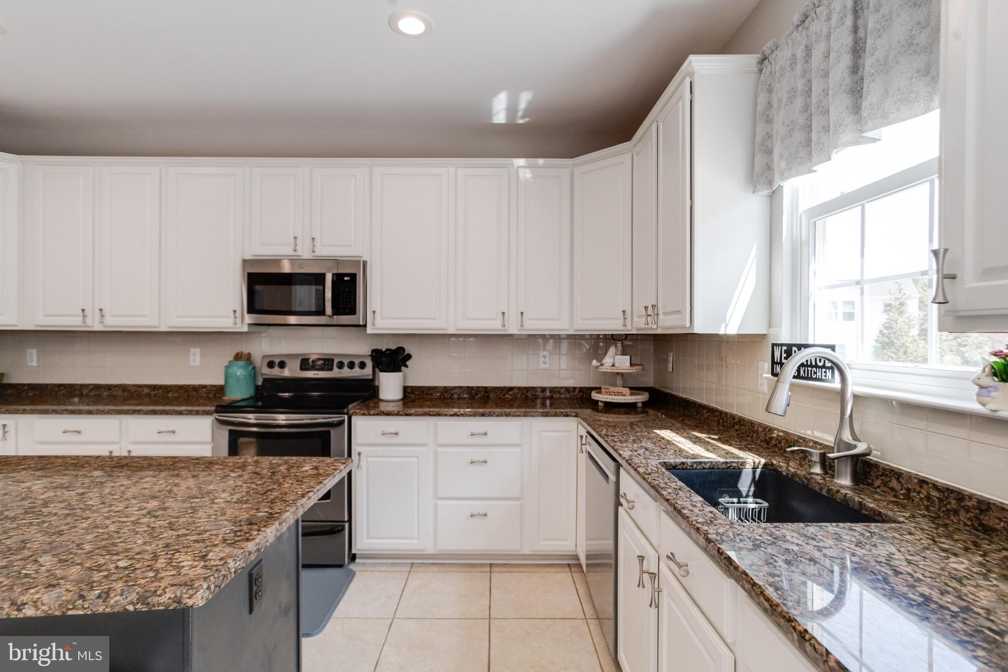 1705 Stone Ridge Court Bel Air, MD 21015 - Photo 32 of 81 a kitchen with granite countertop a sink a counter top space appliances and cabinets