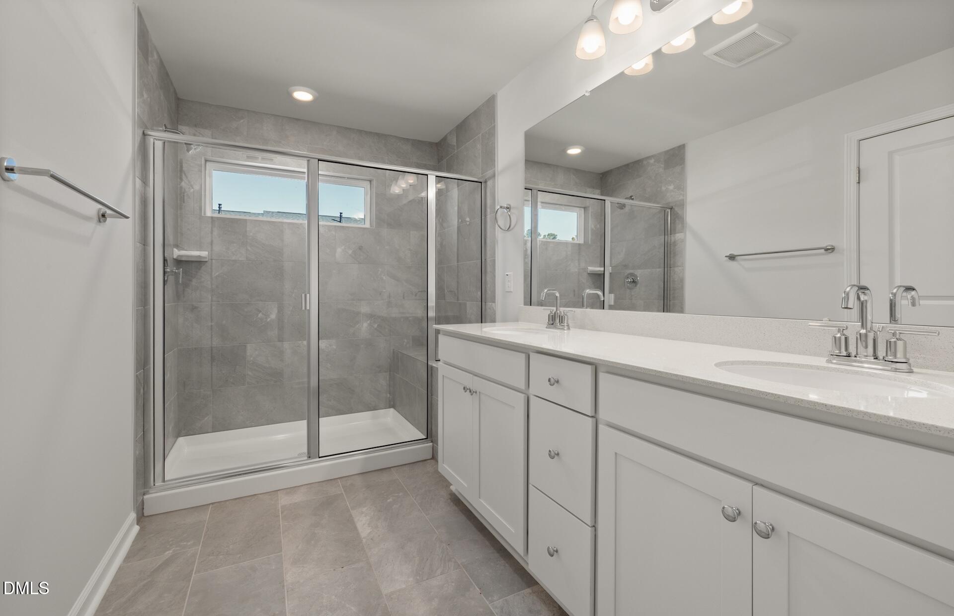 918 Fearless Road Durham, NC 27703 - Photo 14 of 25 a bathroom with double sink and a mirror