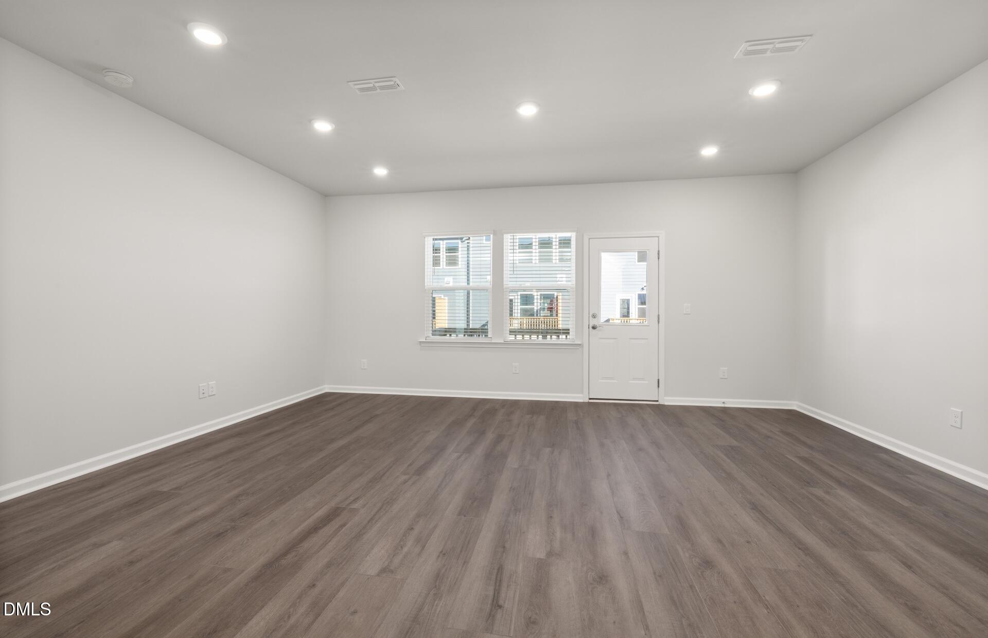 918 Fearless Road Durham, NC 27703 - Photo 8 of 25 an empty room with wooden floor and windows