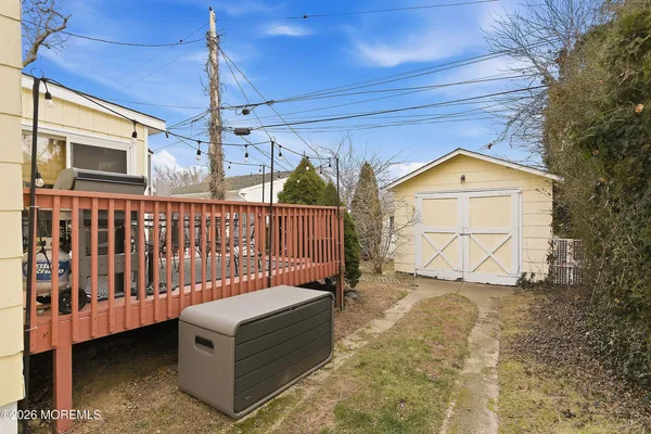 a view of a backyard with a wooden fence