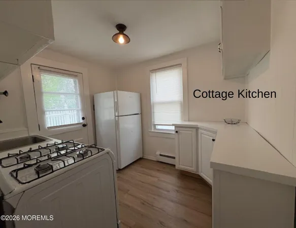 a kitchen with a refrigerator and a stove