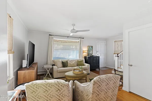 a living room with furniture a large window and a flat screen tv