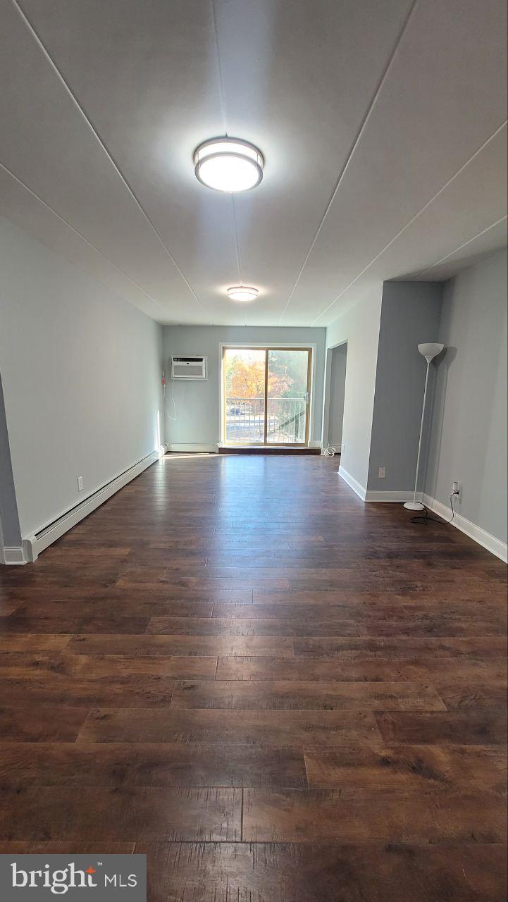 1575 West Street Road, Unit 832 Warminster, PA 18974 - Photo 4 of 14 an empty room with wooden floor and windows