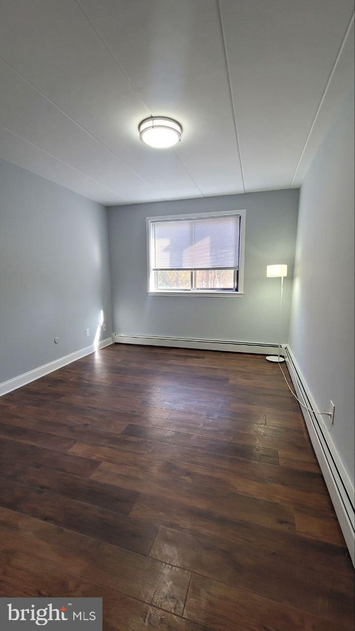 1575 West Street Road, Unit 832 Warminster, PA 18974 - Photo 10 of 14 an empty room with wooden floor and windows