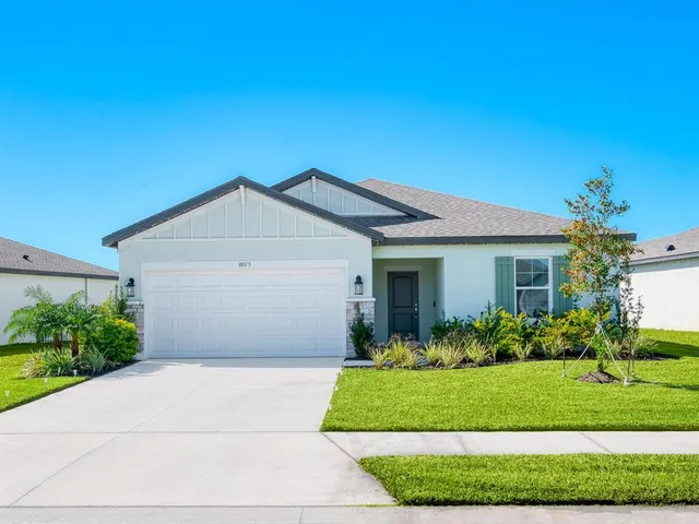 a front view of house with garage and green space