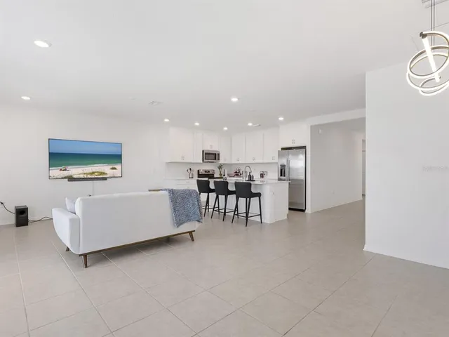 a kitchen with kitchen island a refrigerator stove microwave and cabinets