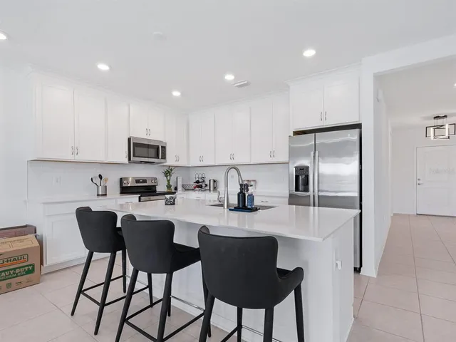 a kitchen with cabinets appliances a sink and a counter top space