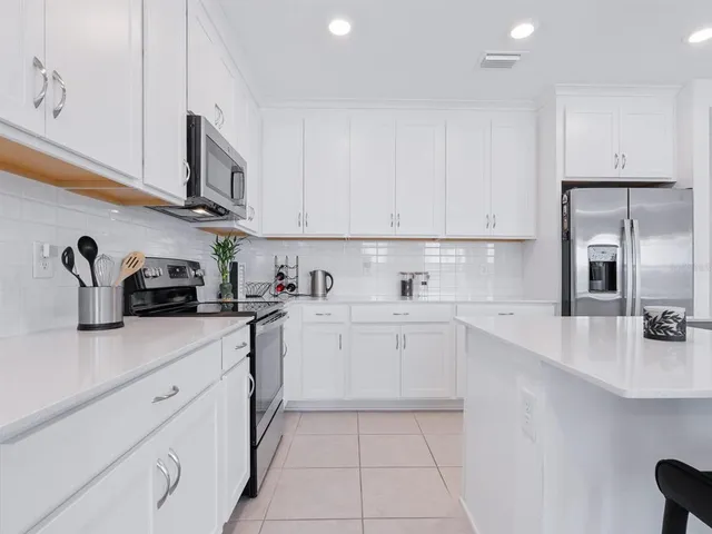 a kitchen with a sink a stove and cabinets