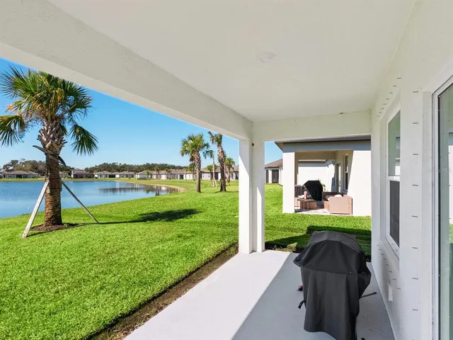 a view of house with backyard and glass door
