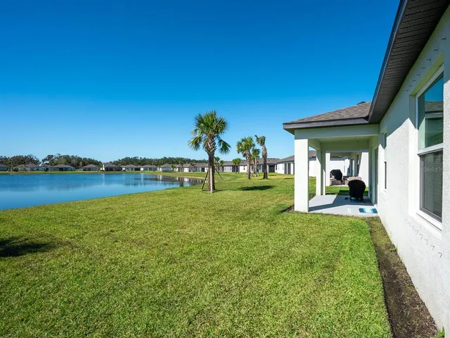 a view of a lake with houses in the back