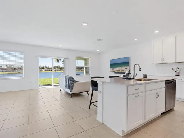 a living room with furniture a flat screen tv and a window
