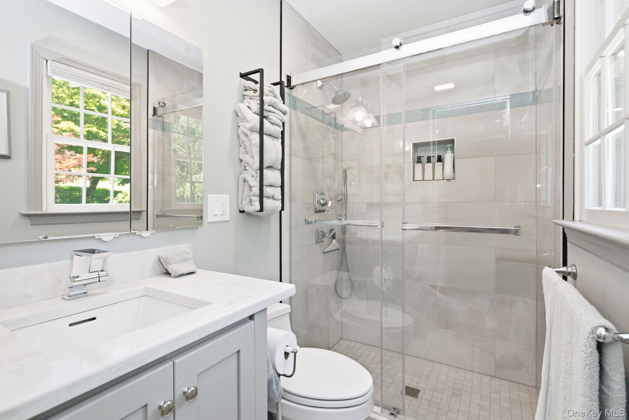 32 Bedell Road Katonah, NY 10536 - Photo 27 of 49 The newly renovated 2025 primary bath features a frameless glass shower and heated floor.